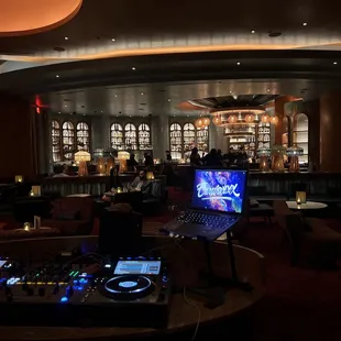 a dj's desk in a dimly lit restaurant