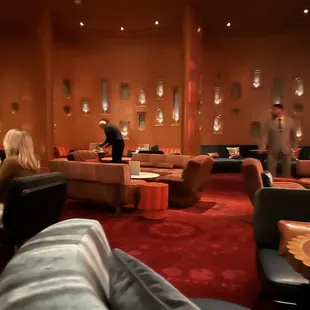people sitting in a restaurant with red carpet