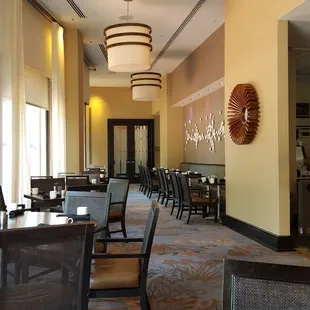 a dining area with tables and chairs