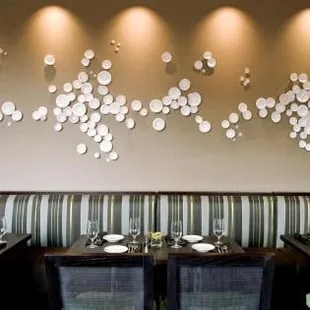 a restaurant with a long booth and a long table with place settings
