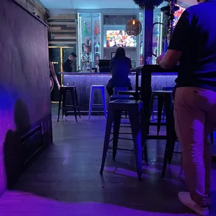 a man and a woman sitting at a bar