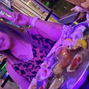 a woman sitting at a table with food