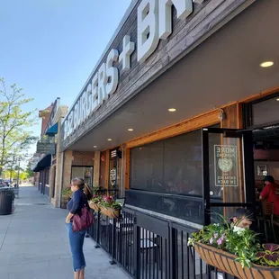 a woman standing outside a restaurant