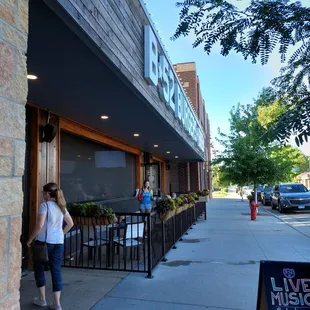 a woman walking down the sidewalk