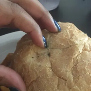 a woman's hand holding a burger