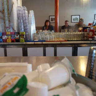 a counter with a lot of bottles and cups