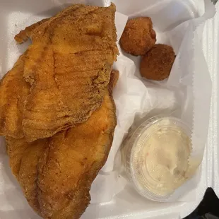 Tilapia dinner with potato salad as the side