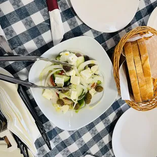  a bowl of salad and bread