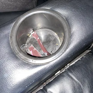 Filthy cup holder with leftover trash