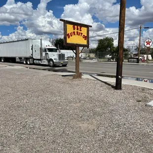 a semi truck parked on the side of the road