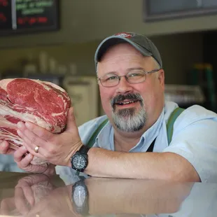 a man holding a piece of meat