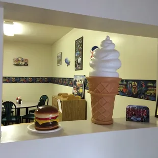 an ice cream cone with a hamburger on top
