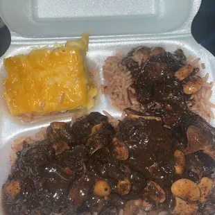 Oxtails with extra gravy rice and peas with Mac and cheese