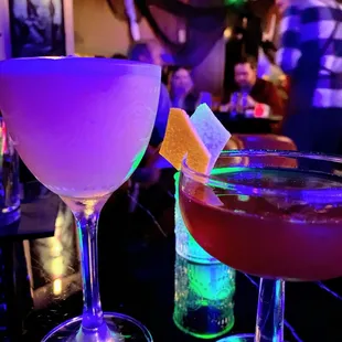 two cocktails on a bar