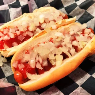 two hot dogs with onions and ketchup