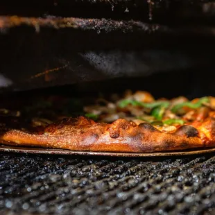 a pizza on a grill