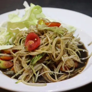 Papaya Salad (Lao Style)- shredded young papaya mixed with tomatoes, lime juice, and fresh chili with your choice of Lao or Thai style sauce