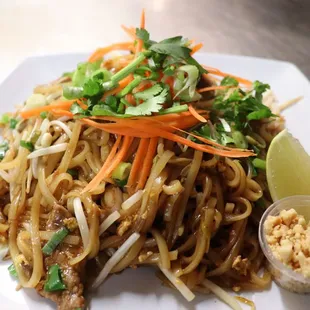 House Pad Thai- Rice noodles, eggs, bean sprouts and green onions in tangy sweeten soy sauce.