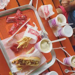 hotdogs and fries on a picnic table