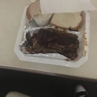 a plate of ribs and bread