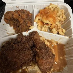 Smothered fried chicken over mashed potatoes yams mac