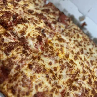 Half square with pepperoni and bacon on one side and pepperoni on the other side
