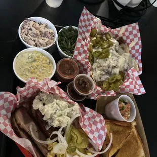 Chipotle slaw, spicy cream corn, green beans, brisket nachos, brisket Macncheese sandwich, brisket, jalapeño sausage, potato salad.