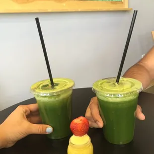 Detox juice, delicious  and healthy !  Ginger with orange juice shot with strawberry on top