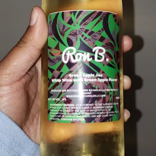 a hand holding a bottle