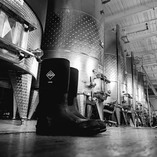 a black and white photo of a boot in a brewery