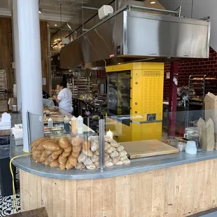 a bakery counter with bread and pastries