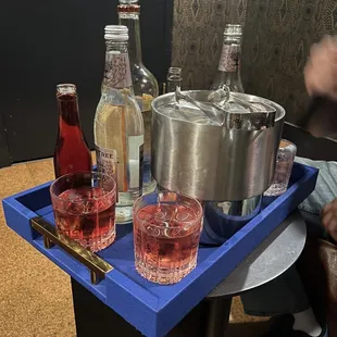 a blue tray with drinks on it