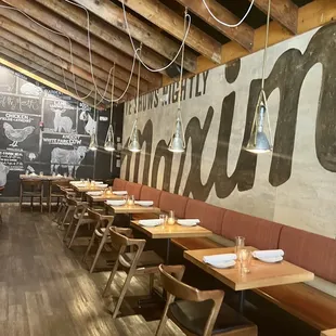 a restaurant with wooden tables and chairs