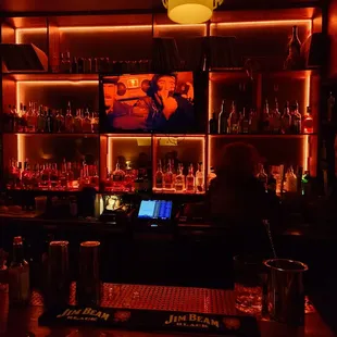 a man sitting at a bar with a laptop in front of him