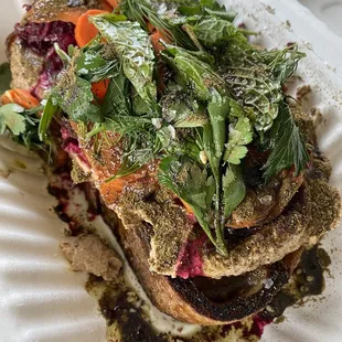 Veggie toast with beets, cashew butter, carrots, herbs, and zaatar. Delish!!