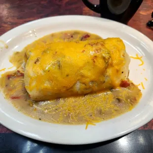 a cheesy chicken entree on a white plate