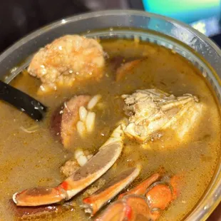 a person holding a bowl of soup