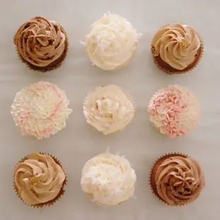 a variety of frosted cupcakes