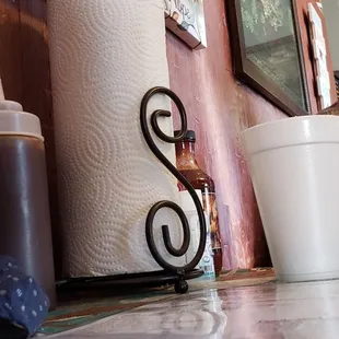 a closeup of a kitchen counter with a roll of toilet paper