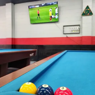 a pool table and a television