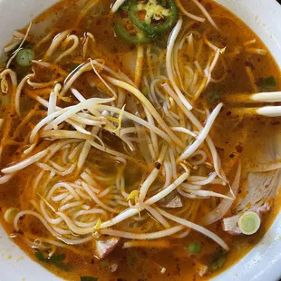 a bowl of soup and chopsticks