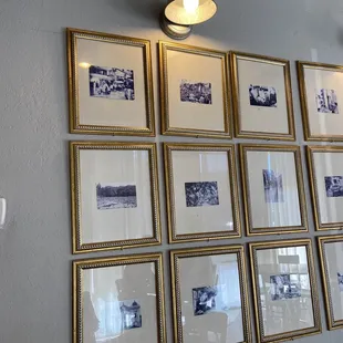 a wall of framed photographs