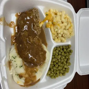 Lunch special hamburger steak with mashed potatoes, Mac and peas