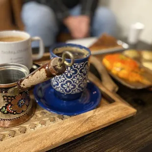 a tray of food and a cup of coffee