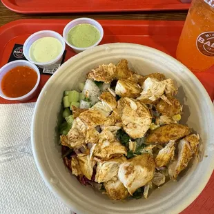 Chicken bowl with hot, parsley tahini, and garlic sauce