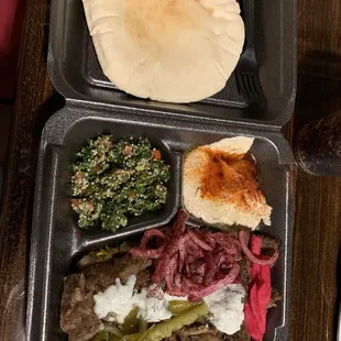 Gyro plate with pickles, onions, tzastiki sauce and pickled veggies, hummus and tabouli for my sides