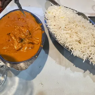 a plate of rice and a bowl of curry