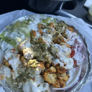 Chicken bowl (bed of rice with grilled chicken, salad, garlic yogurt sauce and green chutney)