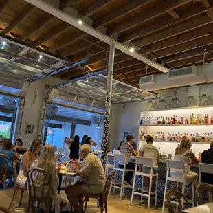 people sitting at tables in a restaurant