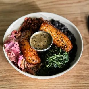 a bowl of food on a wooden table